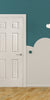 Children's room with a green wall, a white 6-panel door, and colorful toys on a green mat.