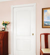 White Camden door in a room with a wooden desk, chair, and painting on the wall.