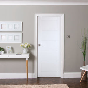 Modern interior design with a white ladder door, console table, chair, and decorative elements against a gray wall.