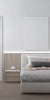 Modern bedroom with a white ladder door, bed, nightstand, and wall art.