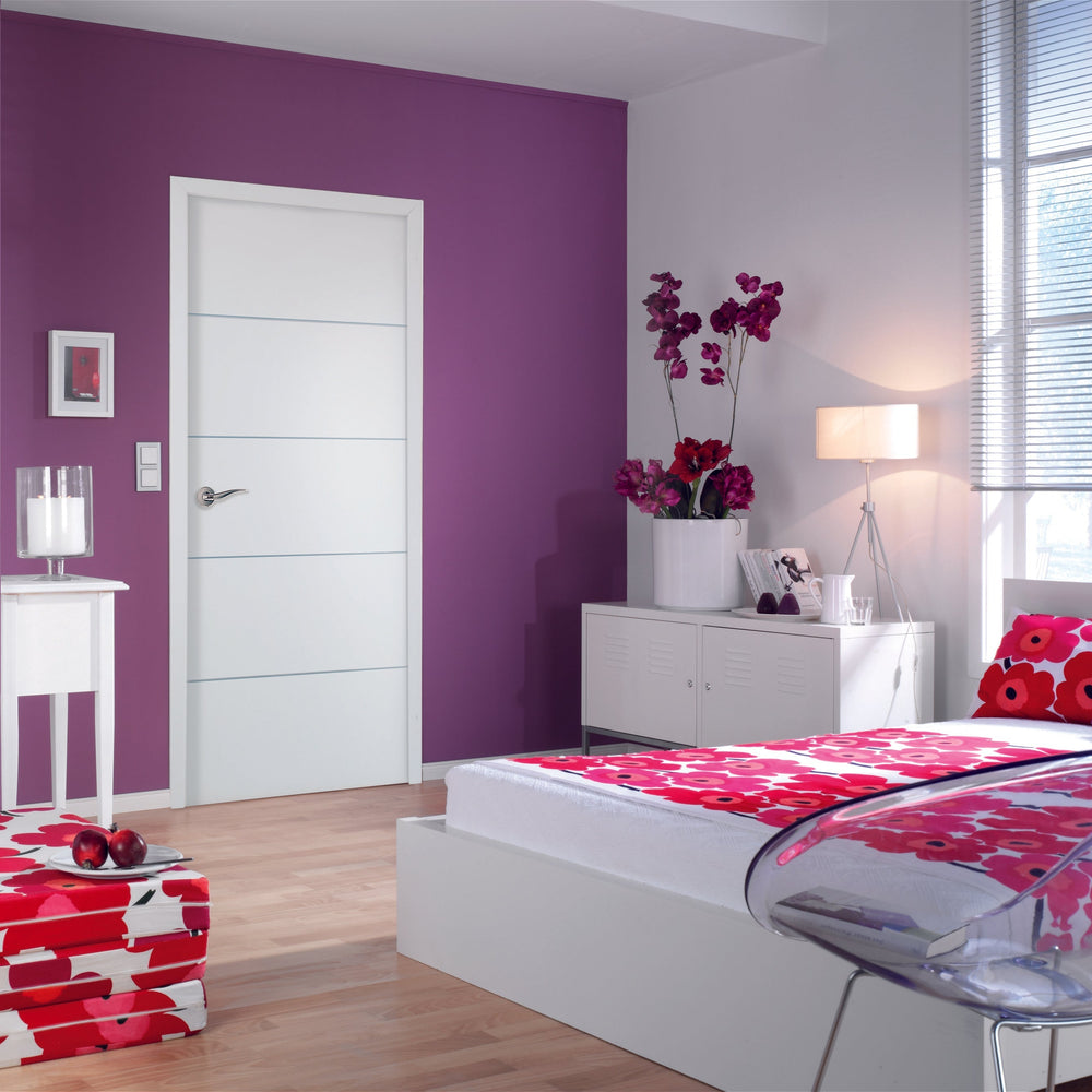 Modern bedroom with white door, purple walls, floral bedding, and a clear chair.