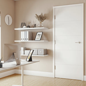 Modern home office with white door in the middle, desk, shelves, and decorative elements.
