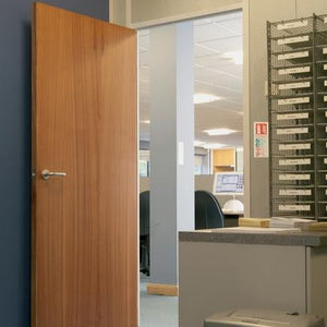 Sapele door opens to an office with a desk and a computer.